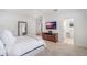 Bright main bedroom with white walls, light carpet, and a view to a white-tiled bathroom at 1230 Mercedes Pl, Orlando, FL 32804