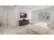 Main bedroom featuring a wall mounted television, dresser, king bed, and neutral tones at 1230 Mercedes Pl, Orlando, FL 32804