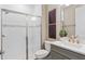 Beautiful bathroom featuring a glass enclosed shower, white subway tile, modern vanity and hardware, and tile floors at 13684 Fresh Ivy St, Winter Garden, FL 34787