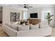 Bright living room with comfortable seating, media cabinet, and wine storage at 13684 Fresh Ivy St, Winter Garden, FL 34787