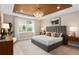 Cozy main bedroom with wood plank ceiling, chandelier, a neutral color palette, and large window at 13684 Fresh Ivy St, Winter Garden, FL 34787