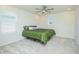 Bright bedroom featuring a floral comforter, a ceiling fan and two windows at 14250 Lanikai Beach Dr, Orlando, FL 32827