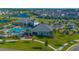 Aerial view of a community pool, clubhouse, playground, palm trees, and walking paths at 14250 Lanikai Beach Dr, Orlando, FL 32827