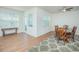 Dining room with decorative rug, modern ceiling fan, and light wood look floors with backyard access at 14250 Lanikai Beach Dr, Orlando, FL 32827