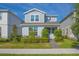 Charming two-story home with manicured lawn and pathway to the front door under a clear blue sky at 14250 Lanikai Beach Dr, Orlando, FL 32827