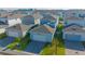 Aerial view of a blue two-story home with a gray roof and a two-car garage at 14250 Lanikai Beach Dr, Orlando, FL 32827