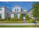 Charming two-story home with manicured landscaping, green lawn and a brick walkway at 14250 Lanikai Beach Dr, Orlando, FL 32827