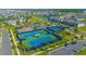 Aerial view of community tennis and basketball courts surrounded by lush landscaping and parking at 14250 Lanikai Beach Dr, Orlando, FL 32827