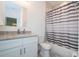 Bathroom with white vanity, granite countertop, and shower with striped curtain at 14742 Sw 43Rd Terrace Rd, Ocala, FL 34473