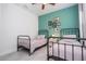 Bedroom featuring two metal beds, a teal accent wall and a ceiling fan at 14742 Sw 43Rd Terrace Rd, Ocala, FL 34473