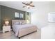 Cozy bedroom featuring a neutral color scheme, ceiling fan, and an ensuite bathroom at 14742 Sw 43Rd Terrace Rd, Ocala, FL 34473