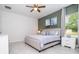 Bedroom featuring a neutral color scheme, ceiling fan, a window and an ensuite bathroom at 14742 Sw 43Rd Terrace Rd, Ocala, FL 34473