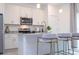 Close-up view of kitchen with white cabinets, stainless steel appliances, and granite countertops with breakfast bar at 14742 Sw 43Rd Terrace Rd, Ocala, FL 34473