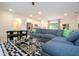 Spacious living room with a gray sectional sofa, a modern coffee table, and an open layout connecting to the kitchen and dining area at 14742 Sw 43Rd Terrace Rd, Ocala, FL 34473