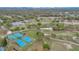 Golf course aerial view with tennis court featuring manicured green grass and mature landscaping at 1601 Billingshurst Ct, Orlando, FL 32825