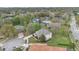 Aerial shot showcasing a well-maintained home with landscaping and a circular driveway at 1601 Billingshurst Ct, Orlando, FL 32825