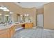 Bathroom featuring double sinks, tile floors, and neutral colors at 1601 Billingshurst Ct, Orlando, FL 32825