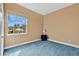 Bedroom with blue carpet and a large window for natural light at 1601 Billingshurst Ct, Orlando, FL 32825