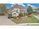 Two-story home featuring brick accents, a well-manicured lawn and mature landscaping at 1601 Billingshurst Ct, Orlando, FL 32825