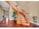 Grand foyer showcasing a curved wooden staircase, gleaming hardwood floors, and elegant decor at 1601 Billingshurst Ct, Orlando, FL 32825