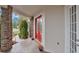 Inviting front porch featuring a red double door entrance, brick columns, and charming flower pot accents at 1601 Billingshurst Ct, Orlando, FL 32825