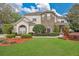 Charming two-story home featuring a manicured lawn and complemented by tasteful landscaping and brick accents at 1601 Billingshurst Ct, Orlando, FL 32825