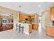 Open kitchen with tile floors, a breakfast bar, and wood cabinets that connects to living area at 1601 Billingshurst Ct, Orlando, FL 32825