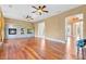 Large living room featuring a brick fireplace, hardwood floors, and natural light at 1601 Billingshurst Ct, Orlando, FL 32825