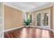 Bright room featuring beautiful hardwood floors, French doors, and natural light at 1601 Billingshurst Ct, Orlando, FL 32825