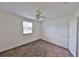 Bedroom with neutral carpet, light walls, a ceiling fan, and a bright window, offering a comfortable and relaxing atmosphere at 1750 E Welch Rd, Apopka, FL 32712