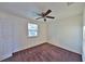 Bedroom with neutral carpet, light walls, a ceiling fan, and a bright window, providing a comfortable and serene space at 1750 E Welch Rd, Apopka, FL 32712