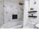 Bright bathroom featuring a tub with stylish black and white geometric-patterned tile surround, and gold finish fixtures at 1913 Woodcrest Dr # B, Winter Park, FL 32792