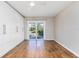 Bedroom featuring wood flooring, sliding glass doors to the outside, and a large white built in wardrobe at 1913 Woodcrest Dr # B, Winter Park, FL 32792