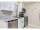 Well-lit kitchen with stainless steel appliances and tile backsplash at 1913 Woodcrest Dr # B, Winter Park, FL 32792