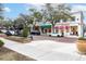 Street view of retail shops and restaurants with awnings, landscaping, sidewalks and parked cars at 1913 Woodcrest Dr # B, Winter Park, FL 32792