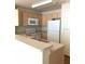 Kitchen featuring white appliances and breakfast bar at 2000 Erving Cir # 102, Ocoee, FL 34761