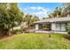 A well kept building featuring an open air carport and a wood deck overlooking a lush, verdant lawn at 2106 Northlake Dr # 2106, Sanford, FL 32773