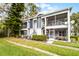 Exterior view of a two-story condo building featuring screened balconies, neat landscaping, and access stairs at 2106 Northlake Dr # 2106, Sanford, FL 32773