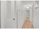 Hallway with wood floors, white walls and multiple storage closets at 2106 Northlake Dr # 2106, Sanford, FL 32773