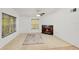 A well-lit living room featuring a decorative fireplace, a ceiling fan, and a large window with natural light at 2106 Northlake Dr # 2106, Sanford, FL 32773