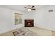 Living room featuring a decorative fireplace, a ceiling fan with lighting, and a large window with natural light at 2106 Northlake Dr # 2106, Sanford, FL 32773