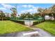 Community tennis court surrounded by lush landscaping and green lawns at 2106 Northlake Dr # 2106, Sanford, FL 32773