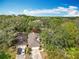 Aerial view of property with mature trees, showcasing landscaping and neighborhood at 216 Springside Rd, Longwood, FL 32779