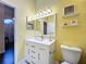 Bright bathroom with a white vanity, modern fixtures, and a decorative mirror at 216 Springside Rd, Longwood, FL 32779