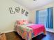 Bedroom with bright decor, including a window with curtains, and hardwood floors at 216 Springside Rd, Longwood, FL 32779