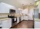 Well-equipped kitchen featuring stainless steel appliances, white cabinetry, and granite countertops at 216 Springside Rd, Longwood, FL 32779