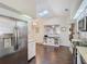 Open kitchen features white cabinets, a skylight, and stainless steel refrigerator at 216 Springside Rd, Longwood, FL 32779