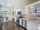 Bright kitchen with white cabinets, stainless steel appliances, and granite countertops at 216 Springside Rd, Longwood, FL 32779