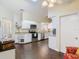 Modern kitchen with stainless steel appliances, white cabinets, and an adjacent seating area at 216 Springside Rd, Longwood, FL 32779