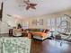 Open concept living room with hardwood floors, ceiling fan, and neutral-colored sectional sofa at 216 Springside Rd, Longwood, FL 32779